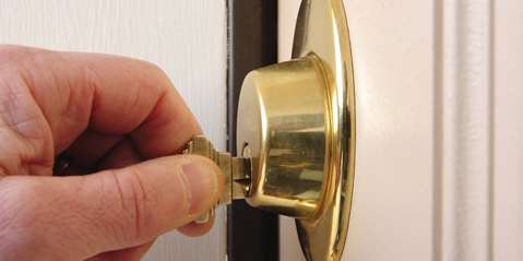 Man unlocking door with key