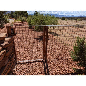 Metal fence with dark bronze lock in the desert