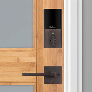 Kwikset bronze smart lock on wood door